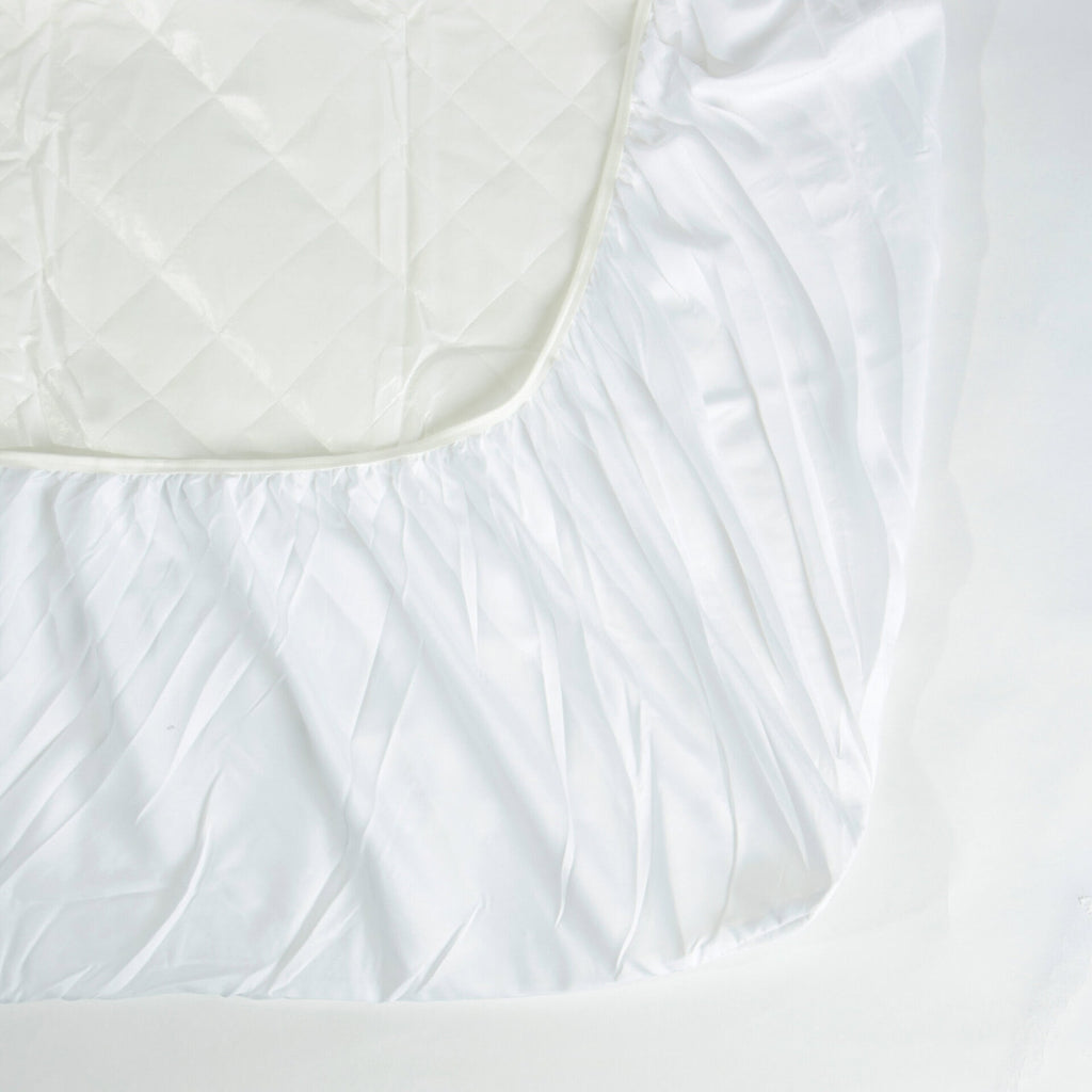 Corner of the Royal Rest Quilted Mattress Protector showing the elasticated fitted skirt