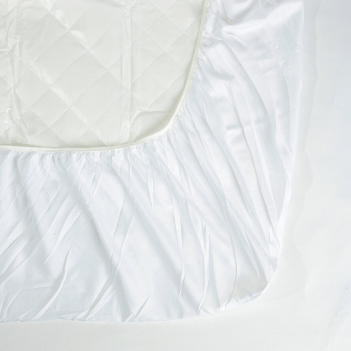 Corner of the Royal Rest Quilted Mattress Protector showing the elasticated fitted skirt